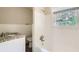 Bathroom with granite vanity top, white tiled walls, and bathtub at 3189 Dogwood Dr, Atlanta, GA 30344