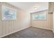Bright bedroom with wood paneled walls and large windows at 3189 Dogwood Dr, Atlanta, GA 30344
