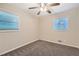 Bright bedroom with neutral walls, grey carpet and ceiling fan at 3189 Dogwood Dr, Atlanta, GA 30344