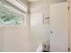 Clean bathroom with white tiled walls, bathtub and window at 3189 Dogwood Dr, Atlanta, GA 30344