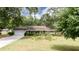 Single-story home with a gray exterior, white trim, landscaped front yard, and attached garage at 2079 Pinehurst Rd, Snellville, GA 30078