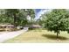 Landscaped front yard of a single-story home with a gray exterior and white trim at 2079 Pinehurst Rd, Snellville, GA 30078