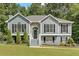 Gray house with stone accents, black shutters, and a landscaped lawn at 4050 Harvest Ridge Dr, Douglasville, GA 30135