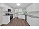 Modern kitchen with white cabinets, granite counters, and stainless steel appliances at 4050 Harvest Ridge Dr, Douglasville, GA 30135