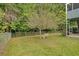 Landscaped backyard with a tree and bench at 4050 Harvest Ridge Dr, Douglasville, GA 30135