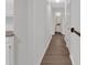 Long hallway with hardwood floors leading to bathroom at 4050 Harvest Ridge Dr, Douglasville, GA 30135