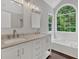 Elegant bathroom with double vanity, large window, and garden tub at 4050 Harvest Ridge Dr, Douglasville, GA 30135