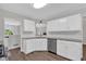 Modern kitchen with white cabinets, granite counters, and stainless steel appliances at 4050 Harvest Ridge Dr, Douglasville, GA 30135