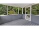Screened porch with gray-painted floor and surrounding woods at 4050 Harvest Ridge Dr, Douglasville, GA 30135