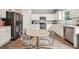 Modern kitchen featuring white cabinets, stainless steel appliances, and hardwood floors at 415 Splash Pointe, Temple, GA 30179