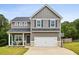 Two story gray house with a two car garage and basketball goal at 415 Splash Pointe, Temple, GA 30179
