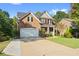 Brick two-story home with stone accents and a spacious lawn at 551 Lincolnwood Ln, Acworth, GA 30101