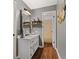 Bathroom with white vanity, mirror, and shelves at 52 Jennifer Ln, Carrollton, GA 30116