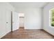 Bright bedroom with hardwood floors, large window, and walk-in closet at 1985 Saint Johns Sw Pl, Atlanta, GA 30315