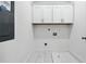 Convenient laundry room with white cabinets and tile flooring at 1985 Saint Johns Sw Pl, Atlanta, GA 30315