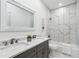 Bathroom boasts double vanity, marble tile, and bathtub at 1985 Saint Johns Sw Pl, Atlanta, GA 30315
