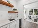 Small wet bar with floating shelves and wine cooler at 1985 Saint Johns Sw Pl, Atlanta, GA 30315