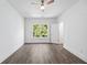 Spacious bedroom with hardwood floors, large window, and ceiling fan at 1985 Saint Johns Sw Pl, Atlanta, GA 30315