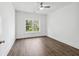 Spacious bedroom with hardwood floors, large window, and ceiling fan at 1985 Saint Johns Sw Pl, Atlanta, GA 30315