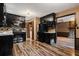 Kitchen boasts black cabinetry, granite counters and tile backsplash at 6945 Butner Rd, Atlanta, GA 30349