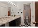 Bathroom with marble vanity, shower, and checkered floor at 6945 Butner Rd, Atlanta, GA 30349