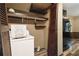Laundry area with washer, dryer and built-in shelving at 6945 Butner Rd, Atlanta, GA 30349