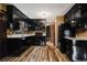 Kitchen with black cabinets, granite counters, and tile backsplash at 6945 Butner Rd, Atlanta, GA 30349