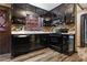 Black kitchen cabinets, granite counters and tile backsplash at 6945 Butner Rd, Atlanta, GA 30349