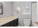 Clean bathroom, featuring a toilet and dark vanity at 6945 Butner Rd, Atlanta, GA 30349