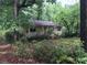 Small house with a front porch, surrounded by overgrown vegetation at 2165 Old Salem Se Rd, Conyers, GA 30013