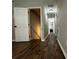 Hallway featuring dark brown wood-look flooring and staircase at 28 Fawn Ct, Sharpsburg, GA 30277