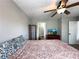 Main bedroom with wood-look floors, large windows, ceiling fan, and dresser at 28 Fawn Ct, Sharpsburg, GA 30277