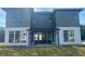 Gray house exterior with white accents, a pergola, and a spacious backyard at 6000 Stallion Rdg, Douglasville, GA 30135