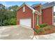 Attached garage with white door and ample space at 9508 Greens Mill Ct, Loganville, GA 30052