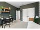 Charming bedroom with a daybed, desk, and green accent wall at 1732 Juniper Berry Way, Loganville, GA 30052