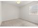 Well-lit bedroom with neutral walls and carpet, offering ample space at 1682 Juniper Berry Way, Loganville, GA 30052