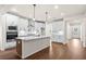 Modern kitchen with white cabinets, quartz countertops, and a large island at 1682 Juniper Berry Way, Loganville, GA 30052