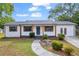 Charming ranch home with white siding, gray accents, and a landscaped yard at 2657 John Petree Rd, Powder Springs, GA 30127