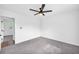 Bedroom with grey carpet, ceiling fan and access to another room at 2657 John Petree Rd, Powder Springs, GA 30127