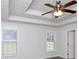 Main bedroom with tray ceiling, ceiling fan, and ample natural light at 80 Stewart Hollow Ln, Covington, GA 30016