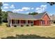 Brick house with a large front porch and yard at 80 Stewart Hollow Ln, Covington, GA 30016
