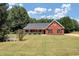 Brick ranch house with front porch and large yard at 80 Stewart Hollow Ln, Covington, GA 30016