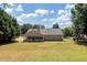 Spacious backyard with large grassy area and screened porch at 80 Stewart Hollow Ln, Covington, GA 30016