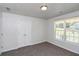 Well-lit bedroom featuring a large window and double-door closet at 80 Stewart Hollow Ln, Covington, GA 30016