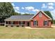 Brick ranch home with front porch and landscaped lawn at 80 Stewart Hollow Ln, Covington, GA 30016