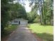 Ranch home with a long private driveway, surrounded by mature trees and a fenced yard at 2585 Westchester Dr, Atlanta, GA 30344