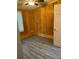 Bedroom with wood paneling, gray flooring, and ceiling fan at 3600 Grady Smith Rd, Loganville, GA 30052