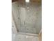 Large walk-in shower with glass enclosure and marble-look tile at 3600 Grady Smith Rd, Loganville, GA 30052