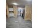 Modern kitchen featuring white cabinets, granite countertops, and gray vinyl flooring at 3600 Grady Smith Rd, Loganville, GA 30052