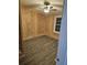 Spacious bedroom with wood-paneled walls, ceiling fan, and gray vinyl flooring at 3600 Grady Smith Rd, Loganville, GA 30052